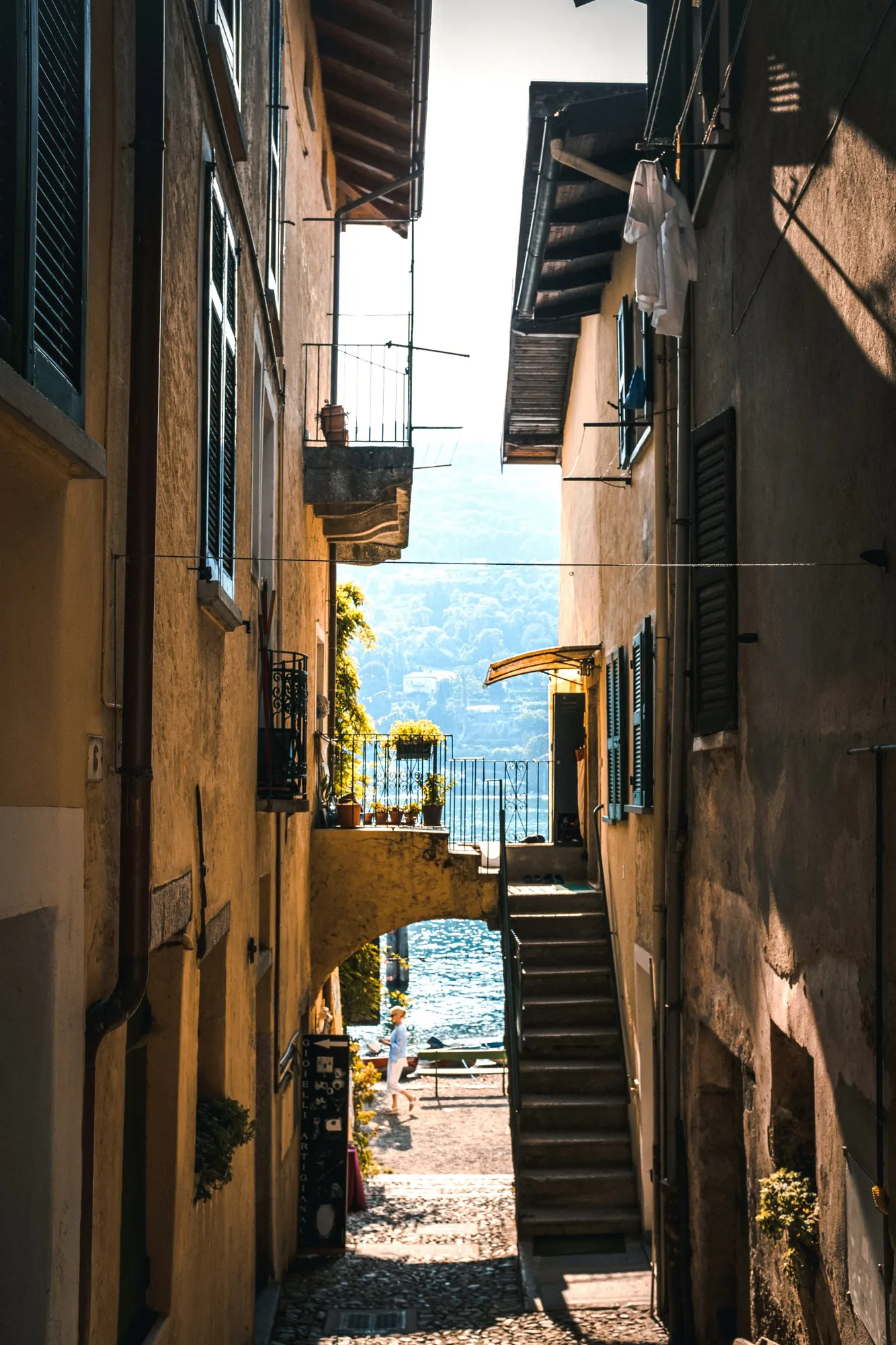 Village lane descending between old houses to the lake