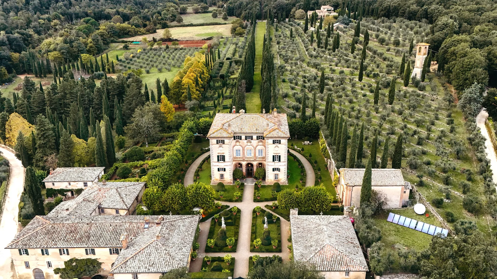 Tuscan estate seen from above, with formal gardens and olive groves